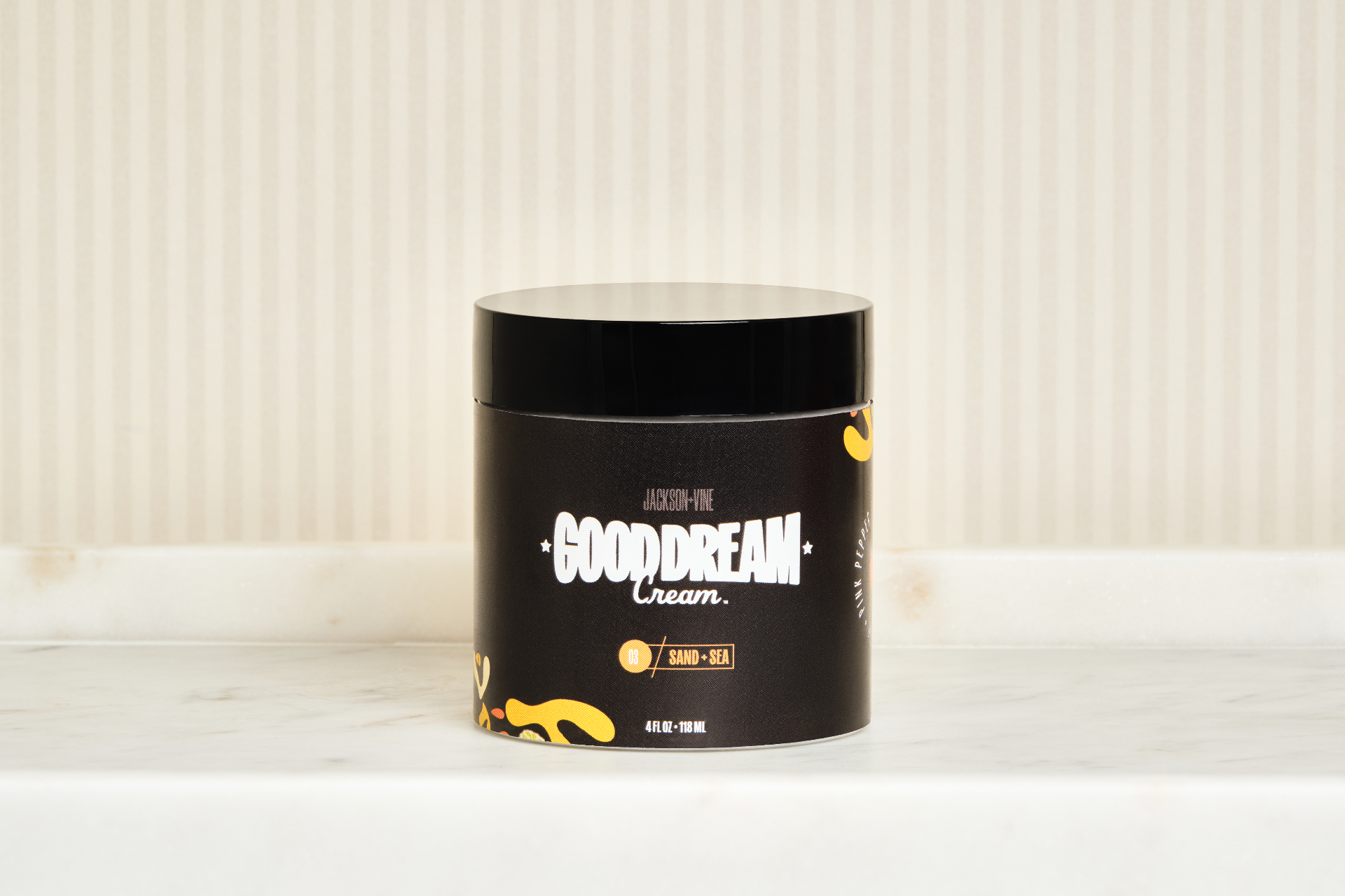 An open jar of Good Dream Cream™ on linen with lavender